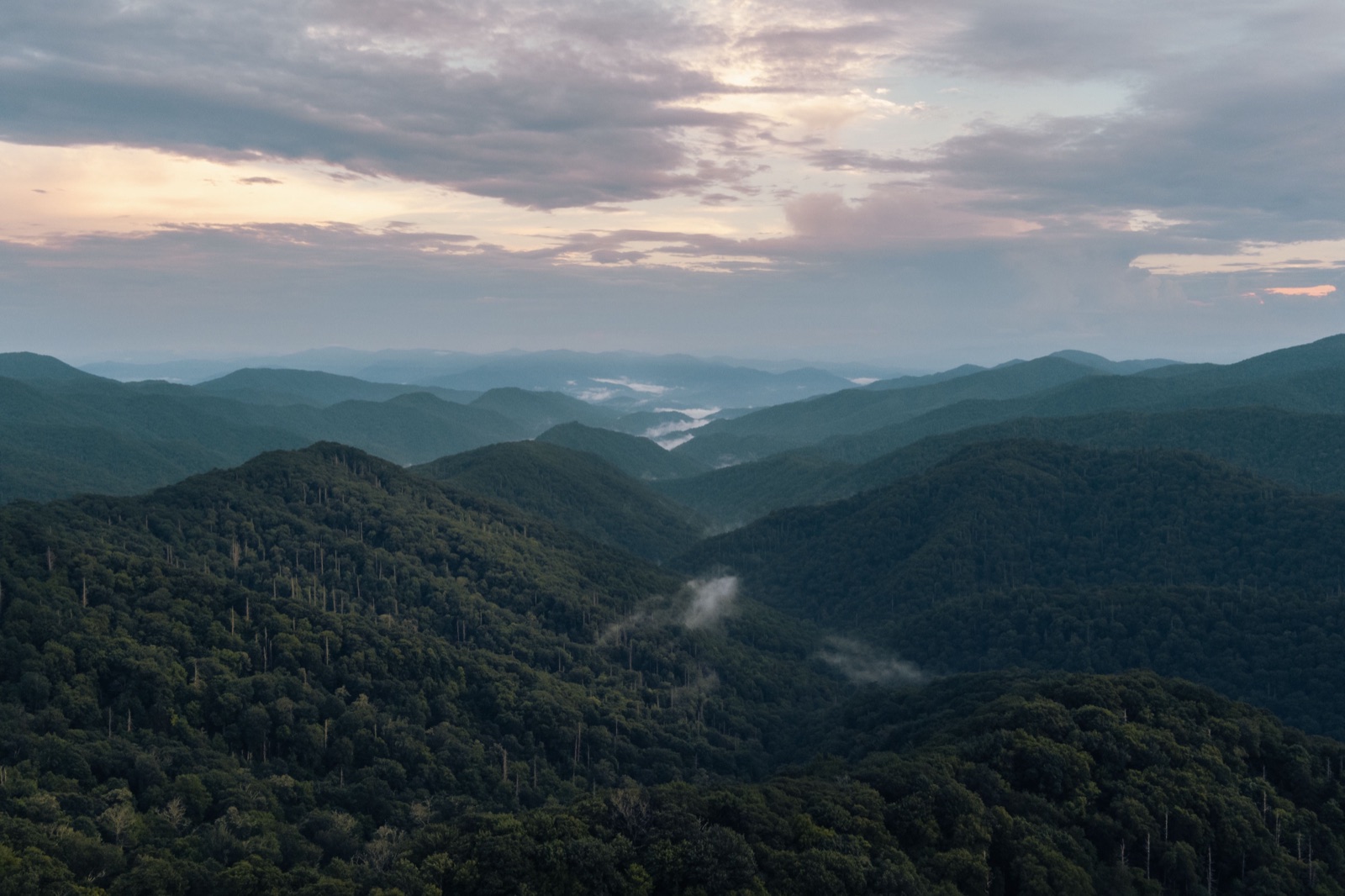 Mist drifting through darkened Smoky Mountain ridges at dusk near Gatlinburg